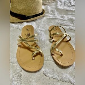 Cross over gold flip flops